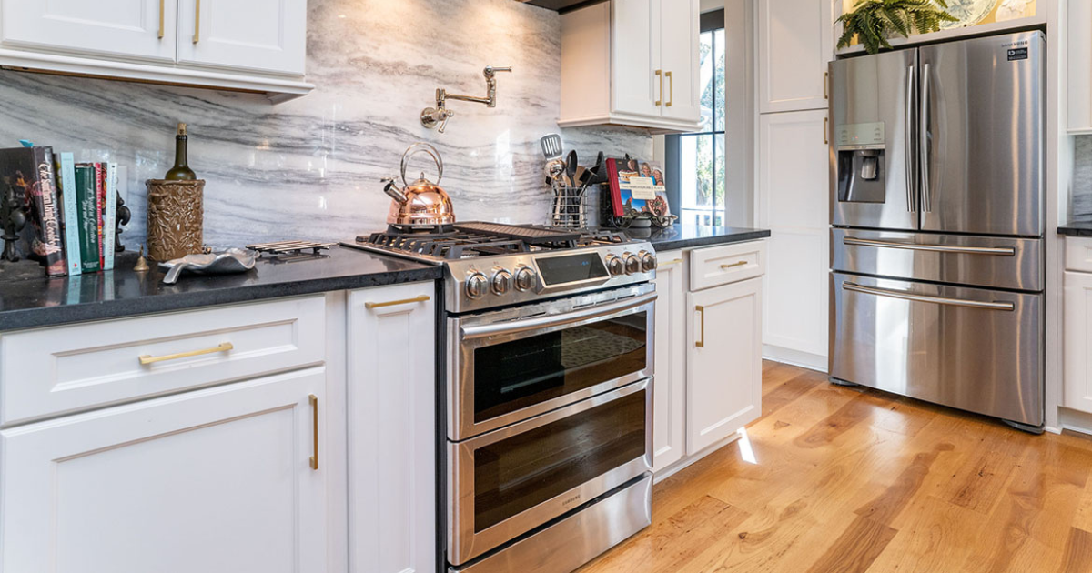 stainless steal oven, white kitchen cabinets