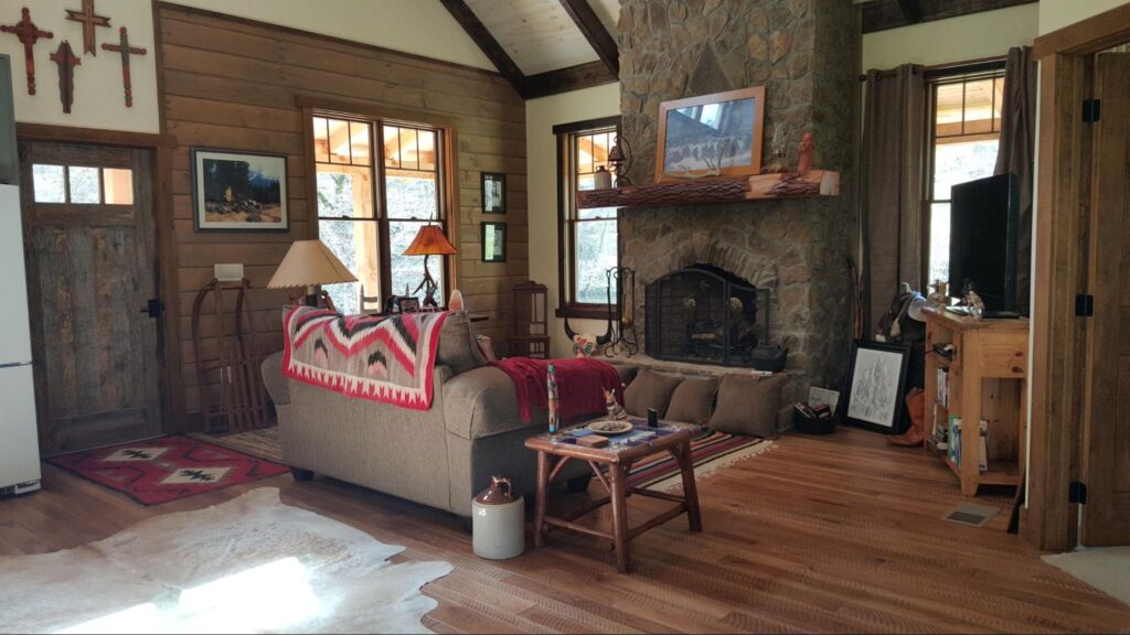 cozy living room with large stone fireplace